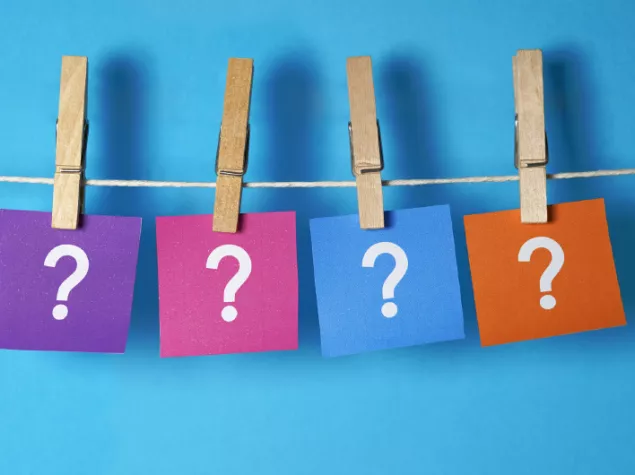 Pages of question marks hanging with pegs