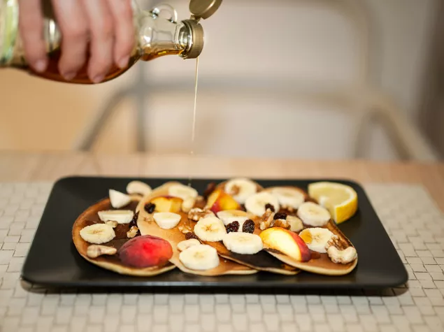 Honey poured onto pancakes