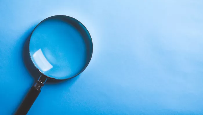 Magnifying glass with blue background