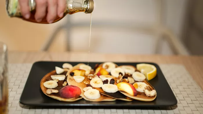 Honey poured onto pancakes